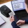 Brother QL-600 Desktop Monochrome Label Printer, up to 2.4" Label Width, No ink required, uses Brother Genuine DK drop-in Rolls for Fast Labeling and easy integration with Microsoft applications